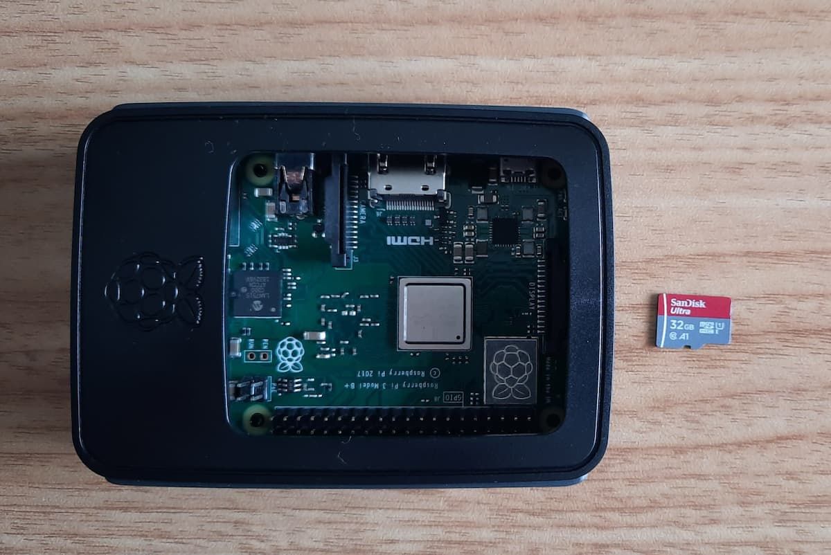 Raspberry Pi in a case beside a microSD card